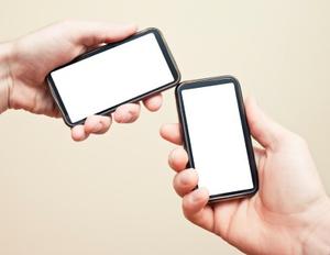 two hands with smartphones