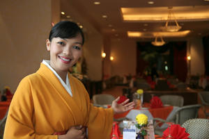 Hostess welcoming customer to restaurant